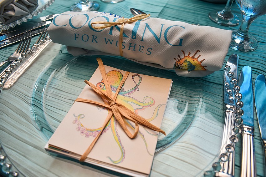 Each plate setting featured a hand-drawn card set and an apron.