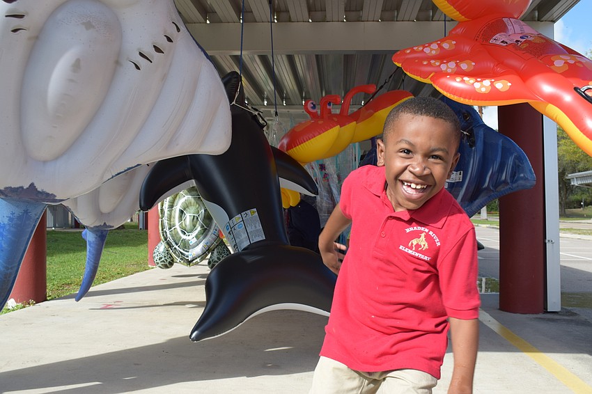 Olivier Jeannot, a first-grader in Nancy King's class, makes his way through the pool floats at the end of the Walk-A-Thon's route.