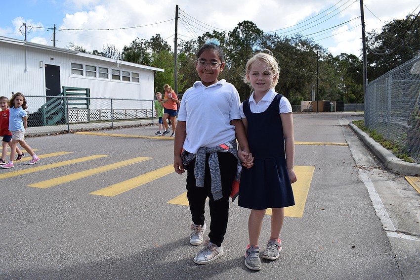 Kindergartners Vanessa Gonzalez-Perez, from Danielle Calabrese's class, and Mattelyn Obey, from Kelly Withers' class, walk together.