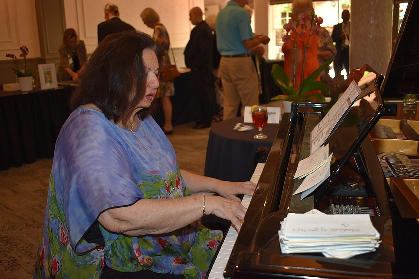 Diana Harrington played the piano as guests entered the luncheon.