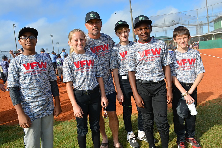 John Rudolph, Elle Hildreth, coach Cory Hildreth, Caden Shirley, Joseph Ziegler and Tucker Pope represented their team, VFW Post 12055 during Opening Day ceremonies. The other players were at a basketball game.