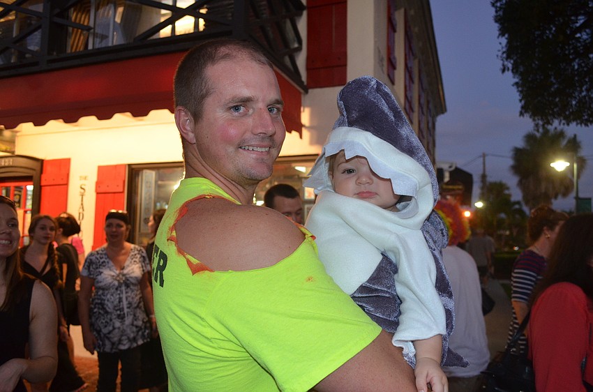 Steve Collison, as a shark attack victim, and son, Carter, 9 months, as a shark