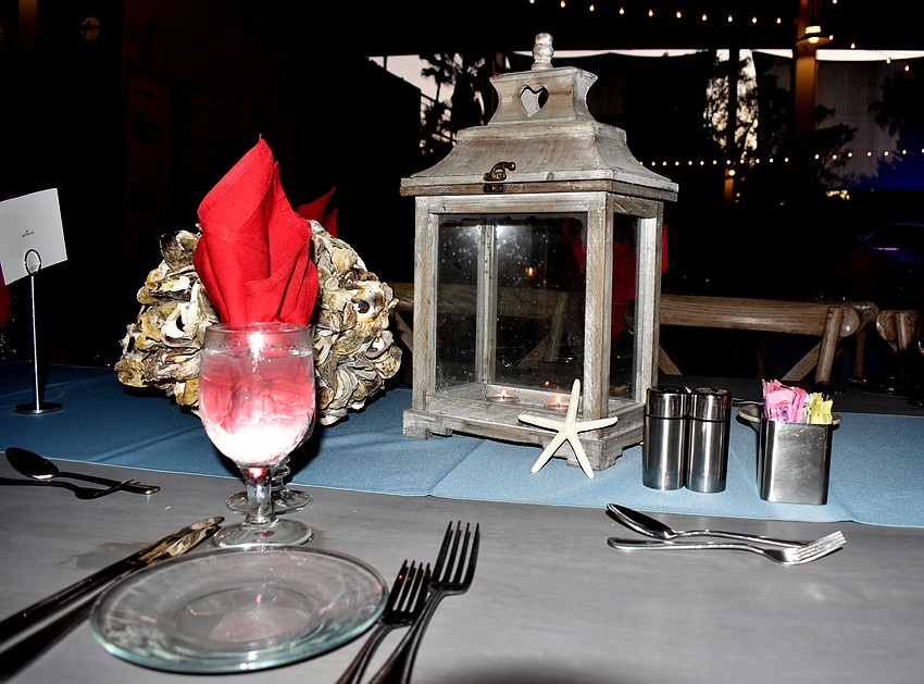Shells, a starfish and coastal colors decorate the tables.