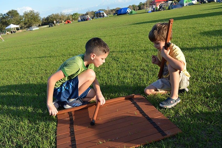 Riverwalk's Dylan Quaid, 12, gets help from his cousine Aidan Mueller, of Sarasota, in setting up a portable table for his family. They camped with Dylan's parents, Stacy and Bill Quaid.