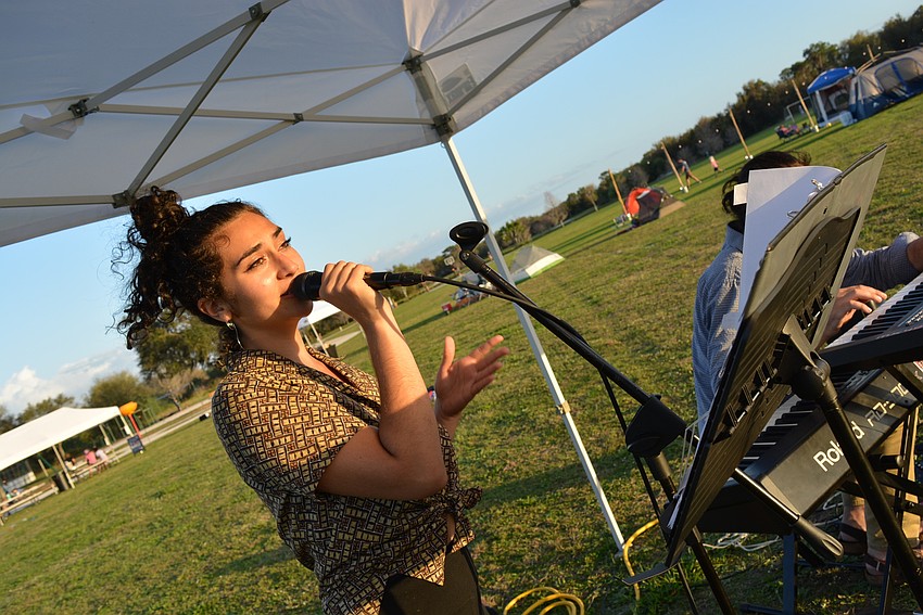 Briana Lutzi and pianist John Hetherington, of the duo Foux Real, performs live for guests to set the tone for the evening. They were told to 