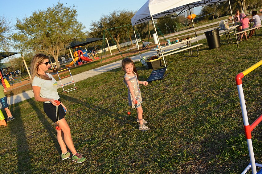 Alison and Cheyenne Chafin, of Serenity Creek, challenge each other in a game of ladder golf.  It was Cheyenne's first time camping.