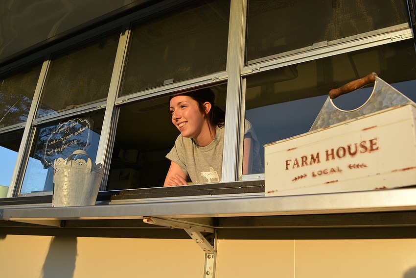 American Honey Creamery's Ai Converse takes an order for a root beer float. The vendor provided ice cream and milkshakes to campers for purchase.