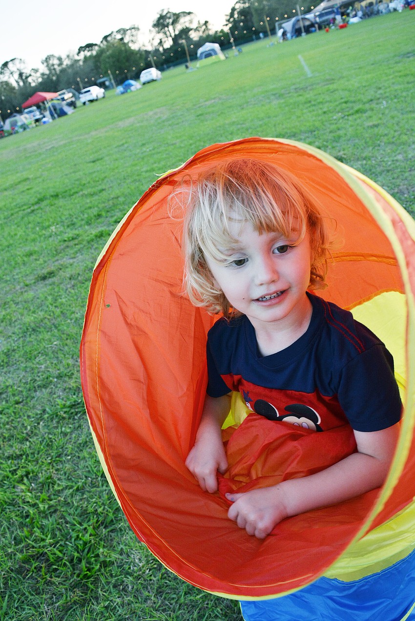Three-year-old Alex Ade had fun playing before sleeping overnight in a tent for the first time with his parents, Maria and Richard Ade, not pictured.