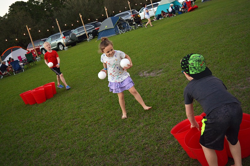 Five-year-old Claire Schroeter plays with her brothers, Cole (behind) and Ben (right).