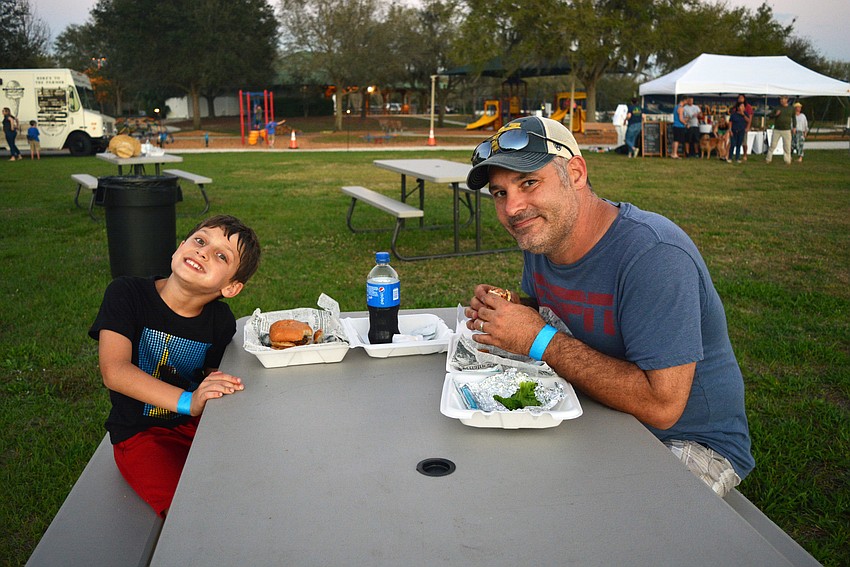 Jake and Mike Minardi, of Country Meadows, feast on hamburgers from Fully Belly Stuffed Burgers as part of their 