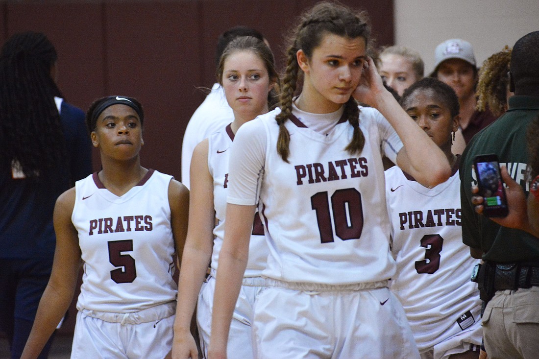 The Pirates walk off the court after their loss to Tampa Bay Tech.