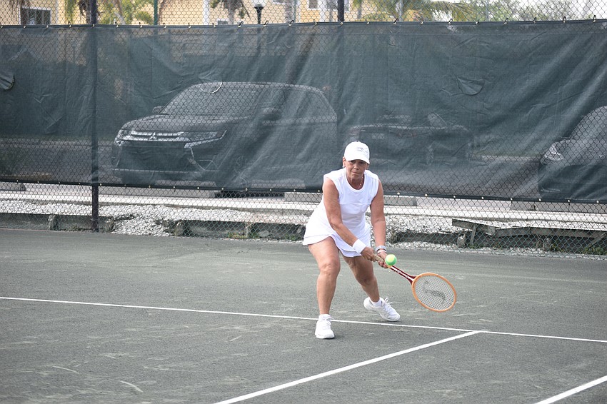 Diane McGrellis had to play with a wooden racquet, which is a little different from a modern racquet.