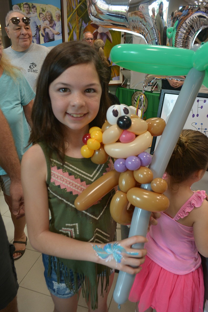 Lakewood Ranch 11-year-old Katherine Vajanyi shows off the balloon art she picked up at the expo.