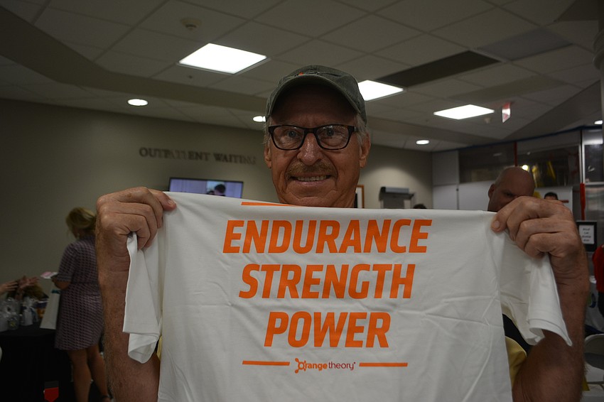 East County's Lee Buntjer shows off the free T-shirt he won from Orangetheory Fitness.