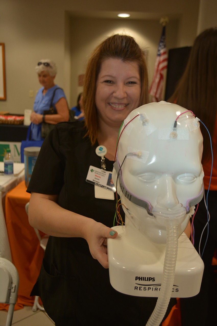Marta Spada shows off an exhibit for Lakewood Ranch Medical Center's Sleep Center.