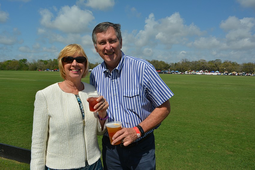 Zollinger Mediation's Freya Robbins and Loyd Robbins of Robbins Real Estate enjoy a beverage before the Observer Cup.
