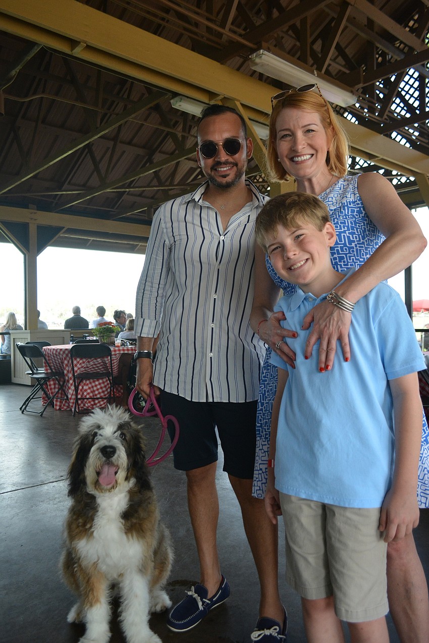McCarver & Moser's Nati Shabat visits with East County Observer Publisher Emily Walsh and her son, Rhys Parry. Shabat's dog, Bijou, joined the fun.
