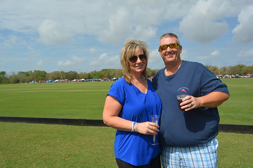 Michael Saunders Chief Marketing Officer Jen Horvat and her husband, Stitch, enjoy an adult beverage as the polo is about to begin.