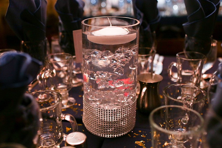 Candles and diamonds glittered on the tables.