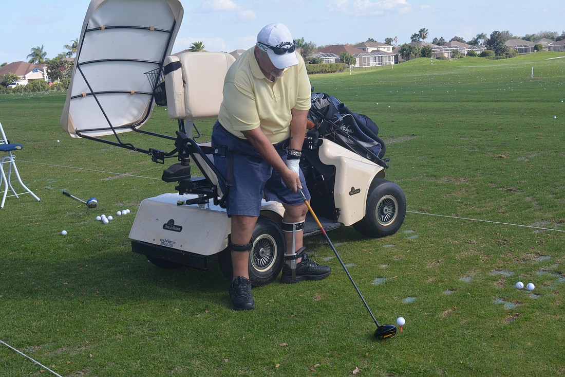 Walter Pawlowski takes a swing with the help of a SoloRider at Sarasota Adaptive Golf.