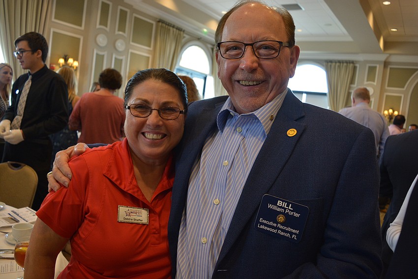Business Alliance member Debbie Shaffer, of Veteran Air, greets Rotary's Bill Porter.