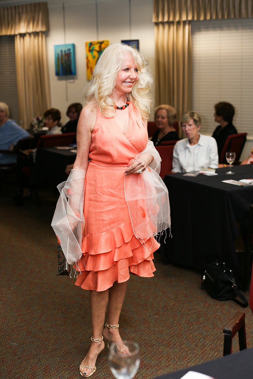 Helen Hermanson models a bright-colored dress.