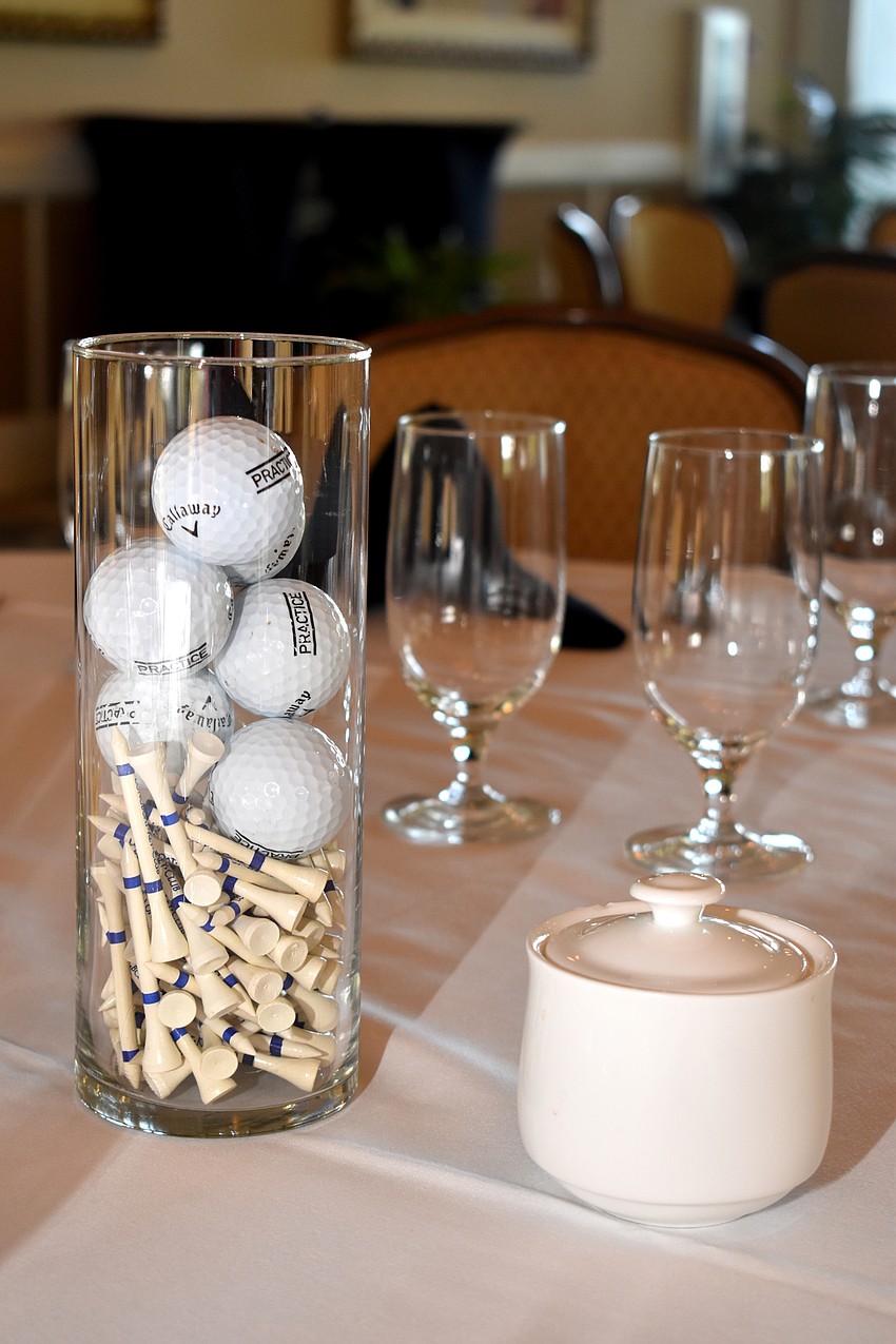 Golf balls and tees sat in the center of each table.
