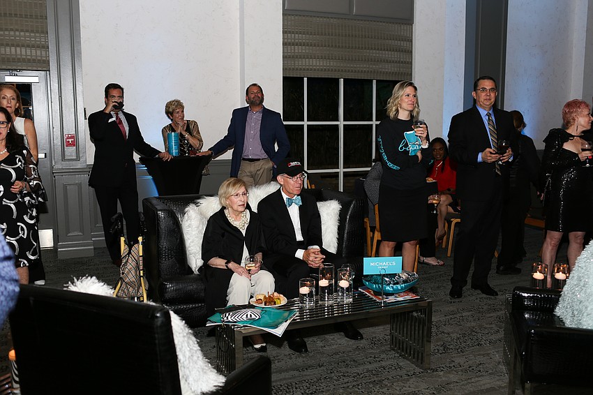 Guets listen to Emily Walsh explain the functions of the new app.