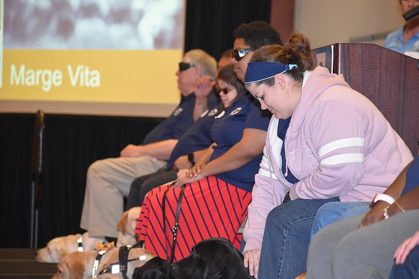 Christalyn Byrd comforts her dog, Midnight, during the ceremony.