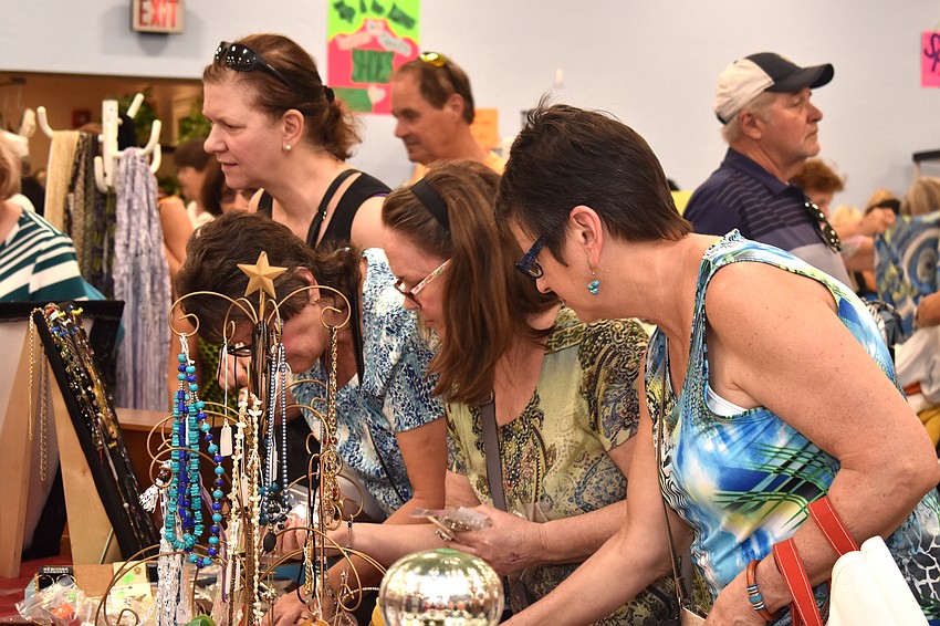 Shoppers peruse the jewelry section.