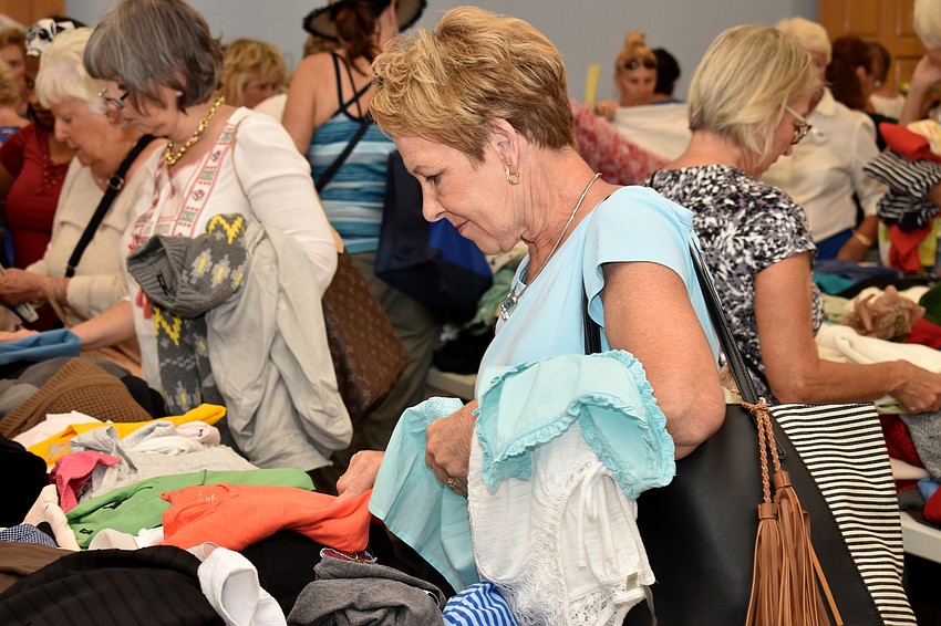 Gail Dufard looks at shirts in the clothing department.