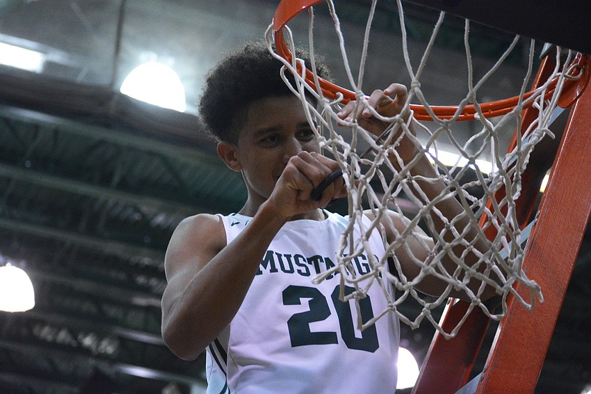 Lakewood Ranch junior guard Keon Buckley cuts down the nets after helping the Mustangs beat East Lake high 57-47 and get to the final four. Buckley had eight points, three rebounds and three assists.