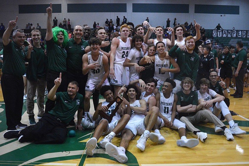 The Lakewood Ranch High basketball team poses with its regional championship trophy after beating East Lake High.