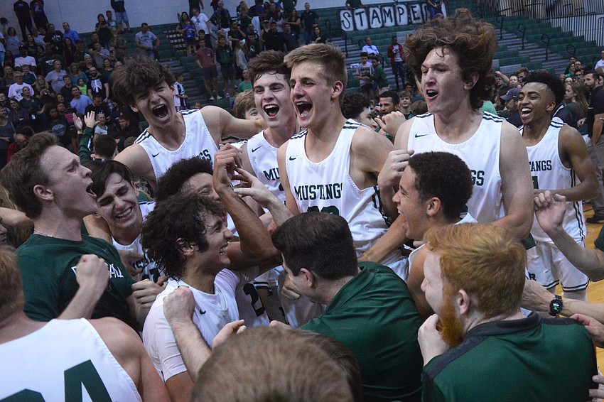The Mustangs mob each other after their regional final win against East Lake High.