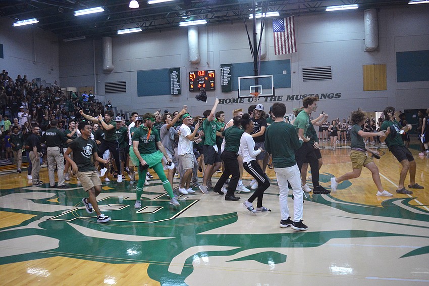 The Lakewood Ranch High crowd rushes the floor after the Mustangs beat East Lake High to advance to the final four.