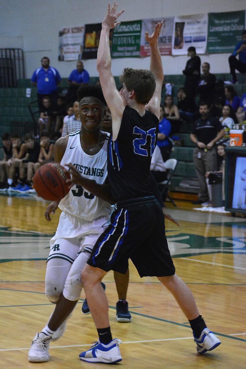 Lakewood Ranch High senior forward Josh Young bumps past East Lake High's Conner Geer.