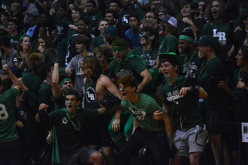 The Mustangs cheering section goes wild after junior guard Christian Shaneyfelt hits a halftime buzzer-beating 3-pointer.
