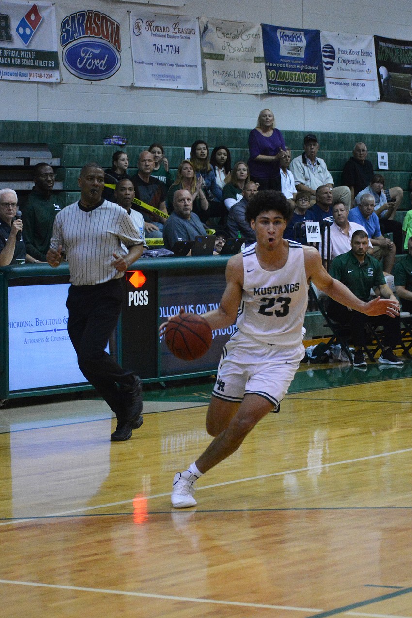 Mustangs junior guard Christian Shaneyfelt drives to the hoop. He finished with 23 points.