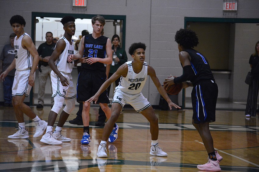 Mustangs junior guard Keon Buckley (20) defends East Lake High guard Dionte Blanch. Lakewood Ranch held Blanch, who averages 22 points per game, to 12 points.