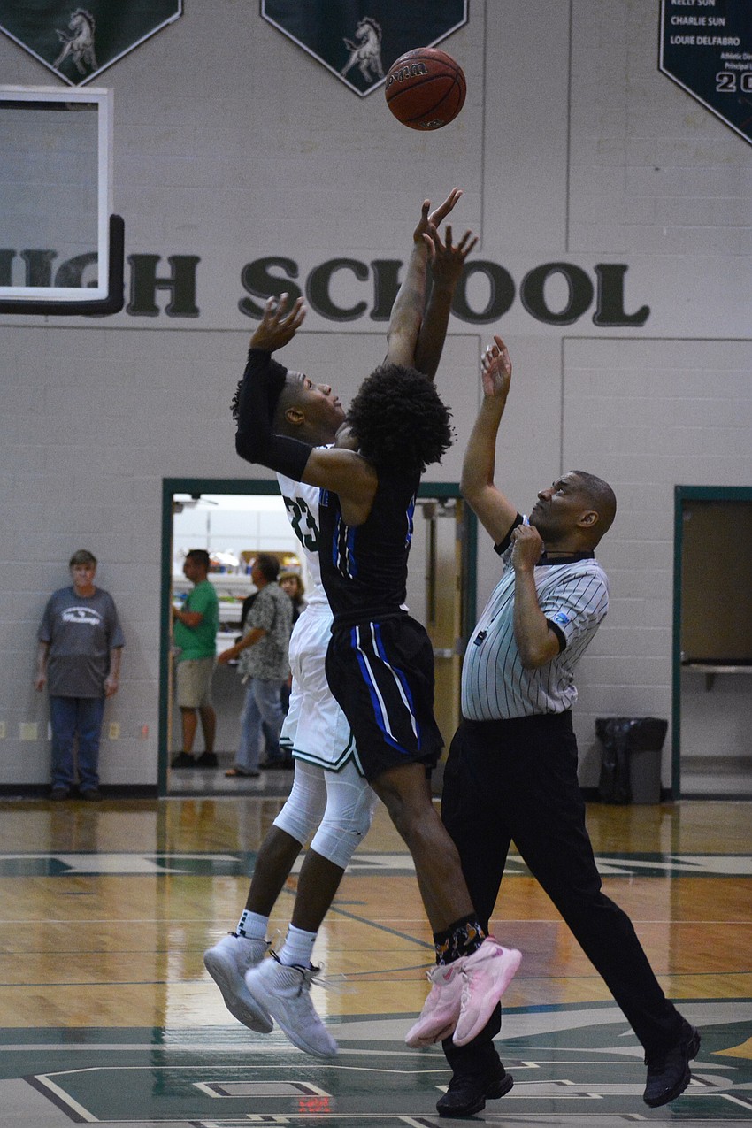 Lakewood Ranch High forward Josh Young (33) takes the opening jump ball against East Lake High guard Dionte Blanch (1).