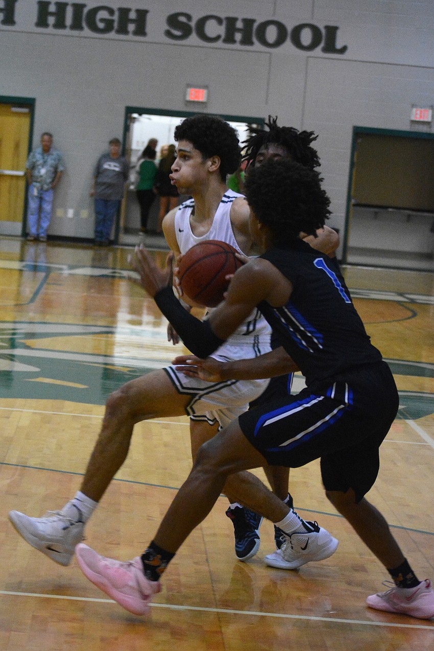 Mustangs junior guard Christian Shaneyfelt drives to the hoop. He finished with 23 points.