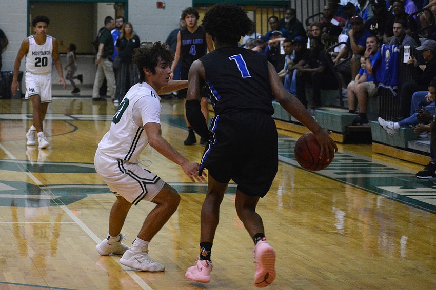 Mustangs junior guard Christian Perez (10) defends East Lake High guard Dionte Blanch. Lakewood Ranch held Blanch, who averages 22 points per game, to 12 points.
