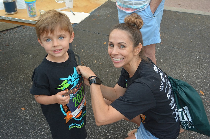 Sarasota's J.J. Twyford has his race number pinned on his shirt by mom, Angie.