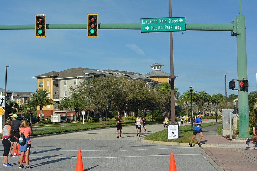 Runners turn off Lakewood Ranch Boulevard on to Lakewood Main Street at the finish of the 5K.