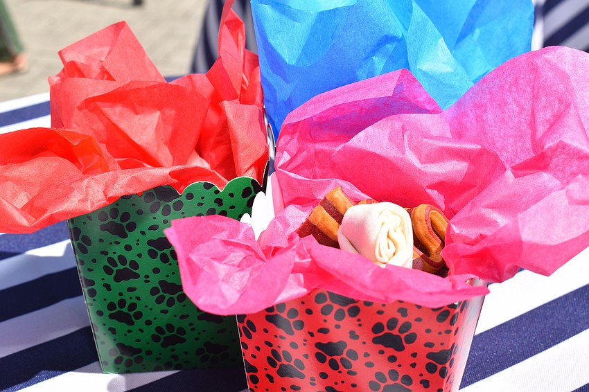 Dog treats were given out to attendees of the fashion show in doggy bags at their tables.