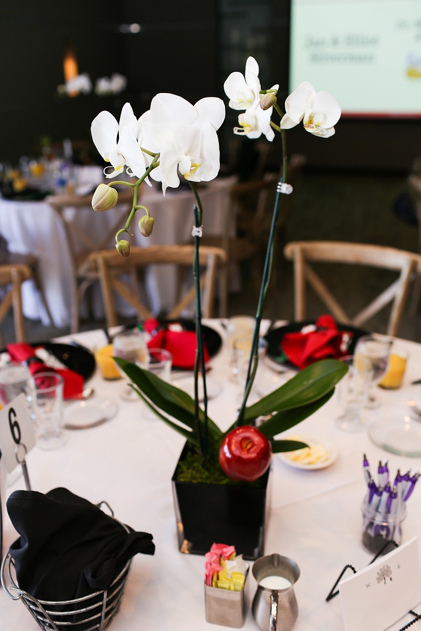 The tables were decorated with orchids and apples.