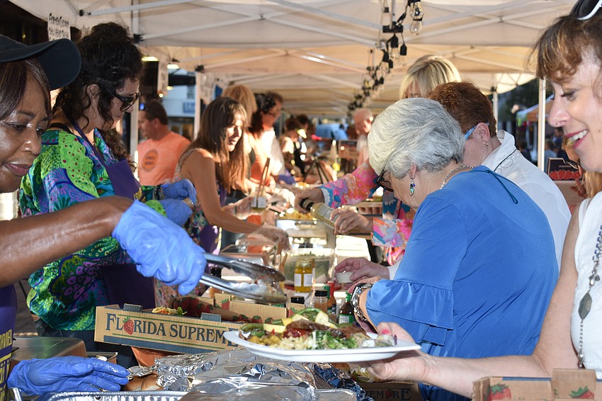 Event-goers lined up to get food from vendors in the market.