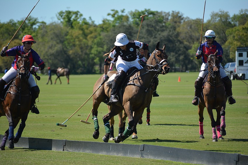 WIPN's Courtney Asdourian goes full-speed ahead despite being along the boards.