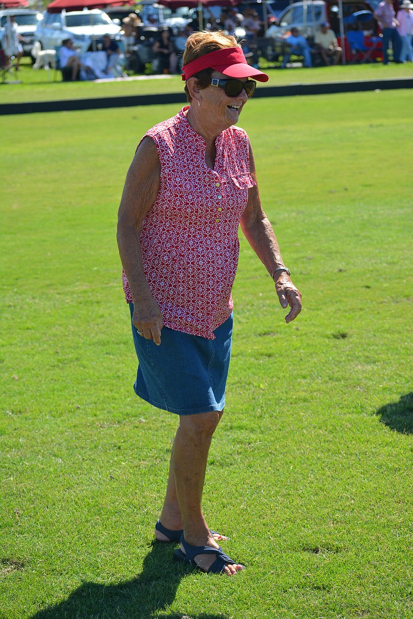 Eagle Trace's Sharon Weaver does her part at halftime filling divots.