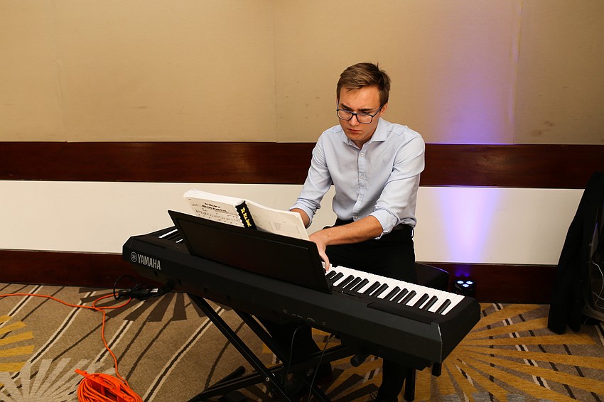 Sam Moss played the piano throughout the party.